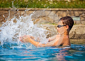 Boy playing in a swimming pool