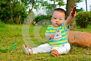 The boy playing in the Swiss Army knife on the lawn