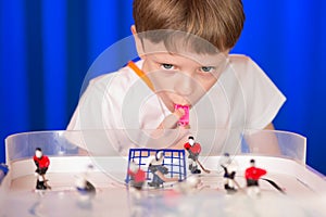 Boy playing table hockey