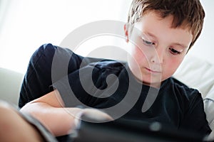 Boy playing on a tablet