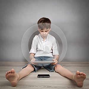 Boy playing on tablet