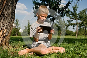 Boy playing in the tablet PC