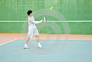 Boy playing tennis