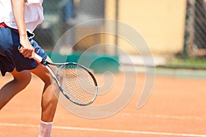 Boy playing tennis. Detail. Large copy.