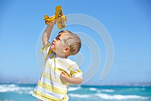 Boy playing with a toy airplane