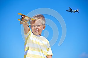 Boy playing with a toy airplane