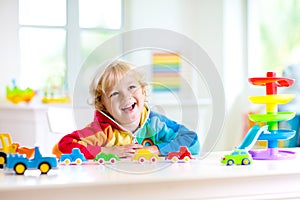 Boy playing toy cars. Kid with toys. Child and car