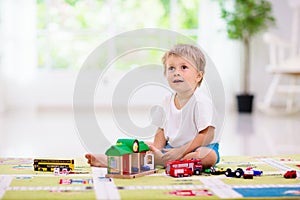 Boy playing toy cars. Kid with toys. Child and car