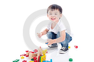 Boy playing toy on the floor over white background