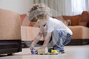 Boy Playing With Toy Train In Living Room