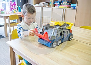 Boy playing with toys in kindergarden