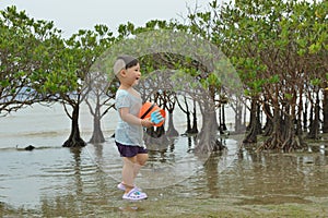 Boy playing toys in swamp