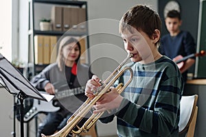 Boy Playing Trumpet In School Orchestra