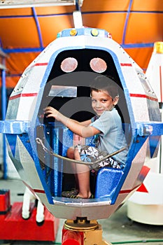 Boy playing in UFO toy