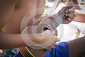 Boy playing the ukulele