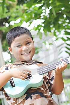 Boy playing the ukulele