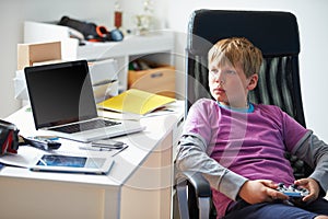 Boy Playing Video Game In Bedroom