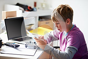 Boy Playing Video Game In Bedroom