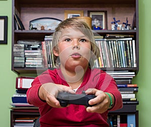 Boy playing a video game console.