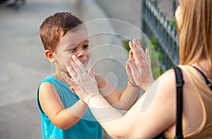 Boy playing wallets with grandmother in the park