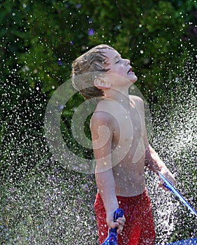 Boy Playing in Water Shower