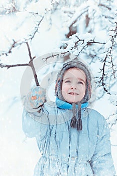 Boy playing in winter forest