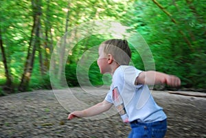 Boy playing in the woods