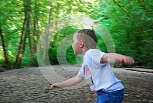 Boy playing in the woods