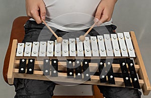 Boy playing the xylophone, mallets in human hands