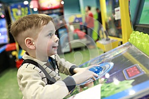 Boy plays arcade game