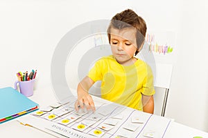 Boy plays in developing game pointing at calendar