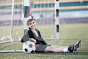 Boy plays football on stadium