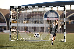 Boy plays football on stadium