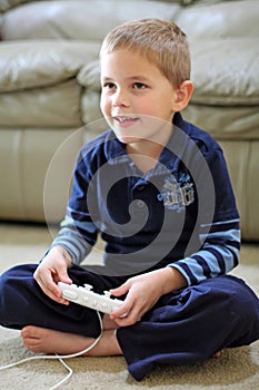 Boy plays handheld video game photo