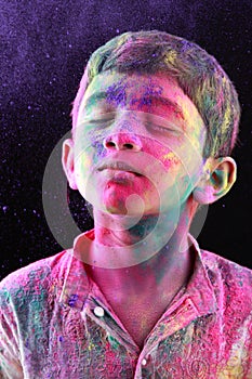A boy plays Holi
