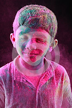 A boy plays Holi