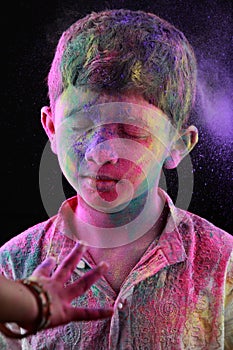 A boy plays Holi