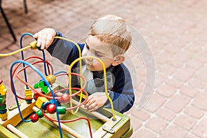 Boy plays with a multicolored toy