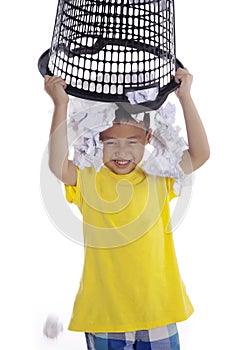 Boy plays with rubbish bin
