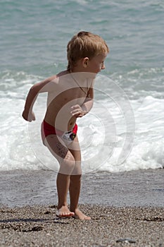 Boy plays at the seaside