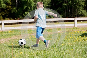 Boy plays soccer in a a blue shirt