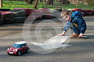 Boy plays with a toy car