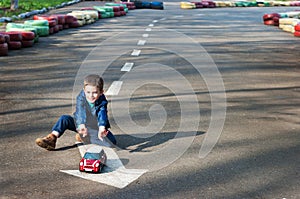 Boy plays with a toy car