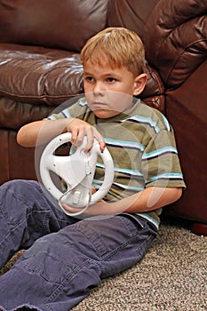 Boy plays video game photo