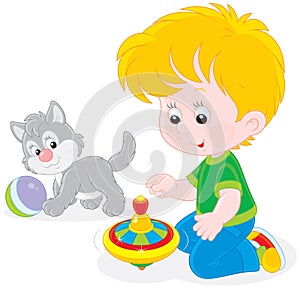 Boy plays with a whirligig and kitten