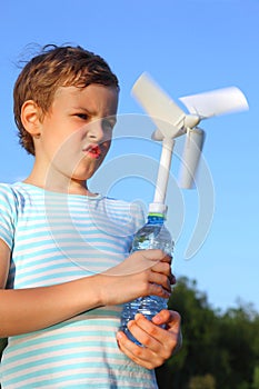 Boy plays with wind-driven generator