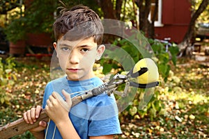 Boy pluck rapples from tree with special device