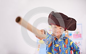 Boy, pointing and pirate hat with portrait in house for playing, adventure and game as creativity. Child, showing and