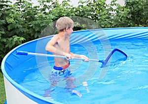 Boy in pool cleaning water