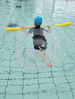 boy in the pool learns to swim photo